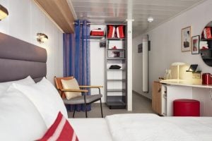 Virgin Voyages XL Sea Terrace storage and entry showing open wardrobe, seating, and modular layout.