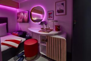 Solo insider cabin with purple lighting showing the desk