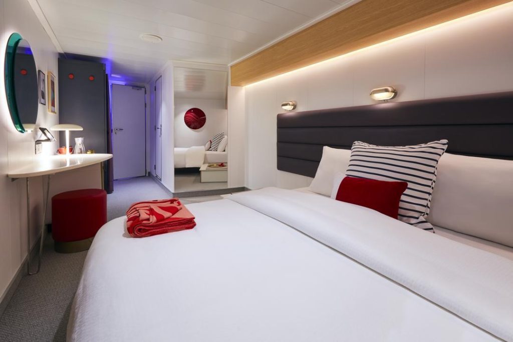 Virgin Voyages Insider cabin close-up of bed with reading lights and modern wood accents