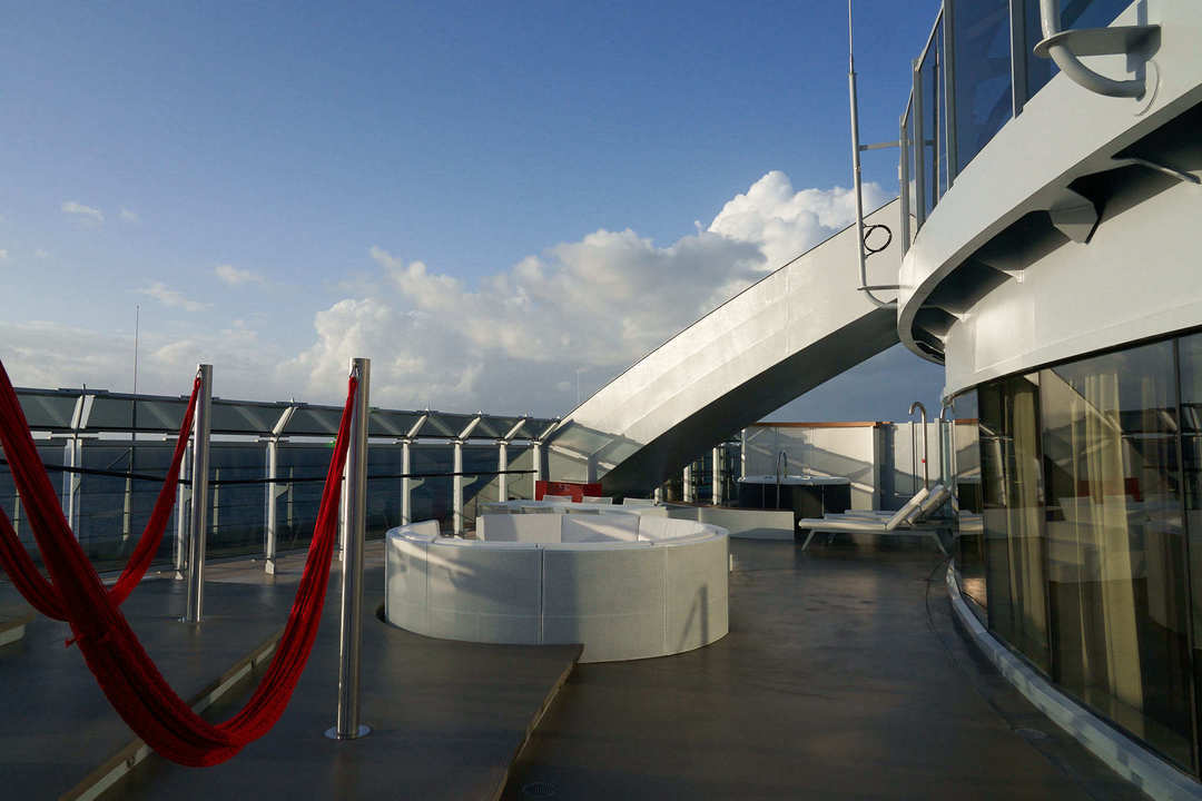 Virgin Voyages Massive Suite private terrace with circular lounge and ocean horizon