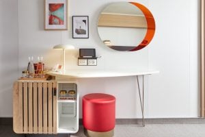 Sea Terrace cabin vanity and minibar with round wall mirror and stool