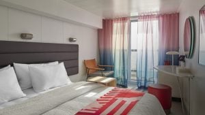 Sea Terrace bedroom with queen bed, sheer sea-view curtains, and natural light